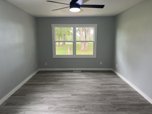 spare room with light hardwood / wood-style floors and ceiling fan