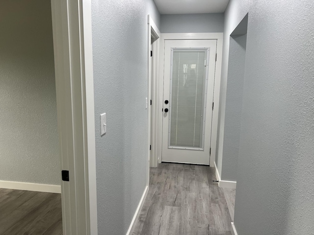 corridor with light wood-type flooring