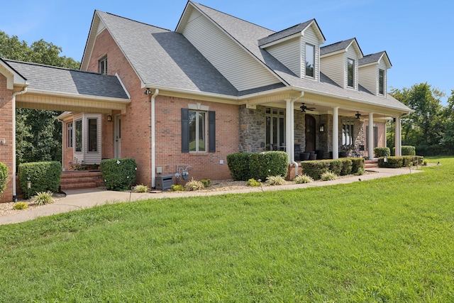 cape cod house featuring a porch, a front yard, and central air condition unit