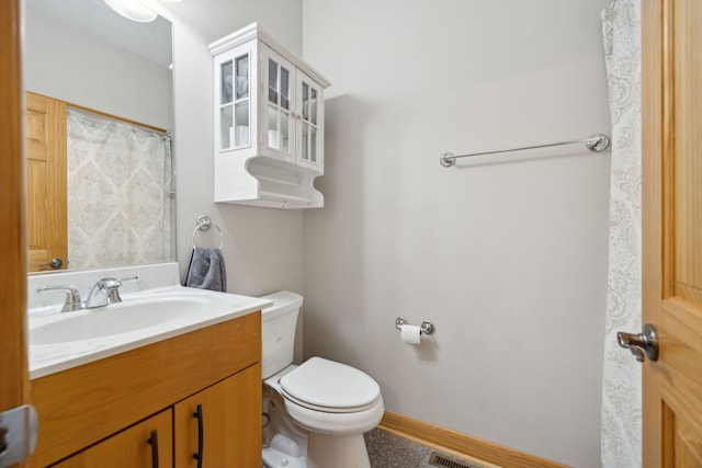 bathroom with toilet and vanity