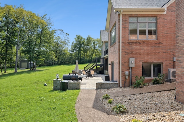 view of yard featuring a shed, a patio area, and outdoor lounge area