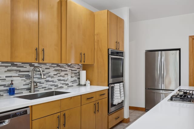 kitchen with tasteful backsplash, light tile patterned floors, stainless steel appliances, and sink