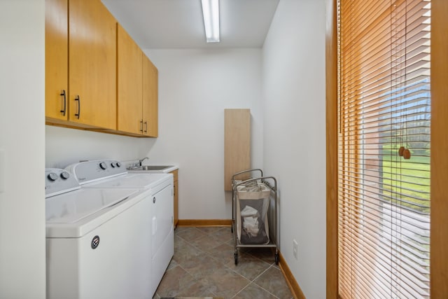 laundry room with light tile patterned floors, cabinets, sink, and washer and clothes dryer