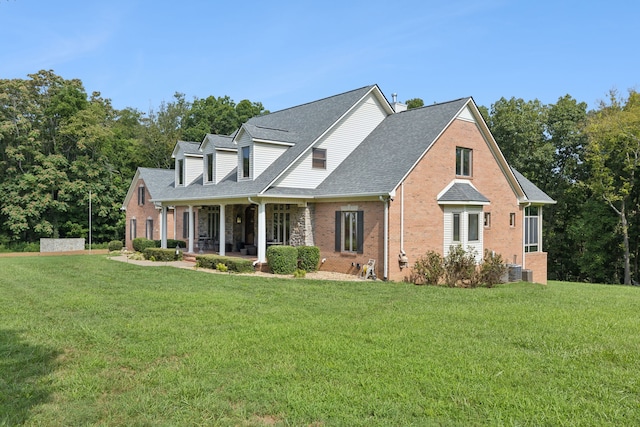 cape cod house featuring a front yard and central air condition unit