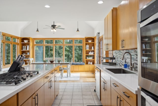 kitchen featuring tasteful backsplash, light tile patterned floors, sink, ceiling fan, and vaulted ceiling