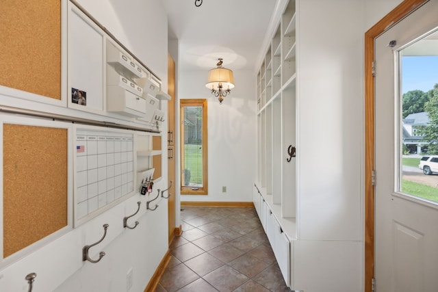 interior space featuring tile patterned flooring and a chandelier