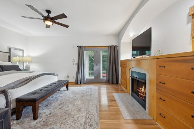 bedroom featuring ceiling fan, french doors, and light hardwood / wood-style flooring