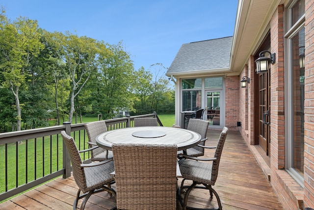 wooden terrace featuring a lawn