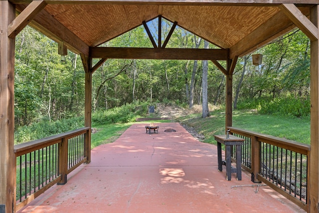 surrounding community with a lawn and a patio area