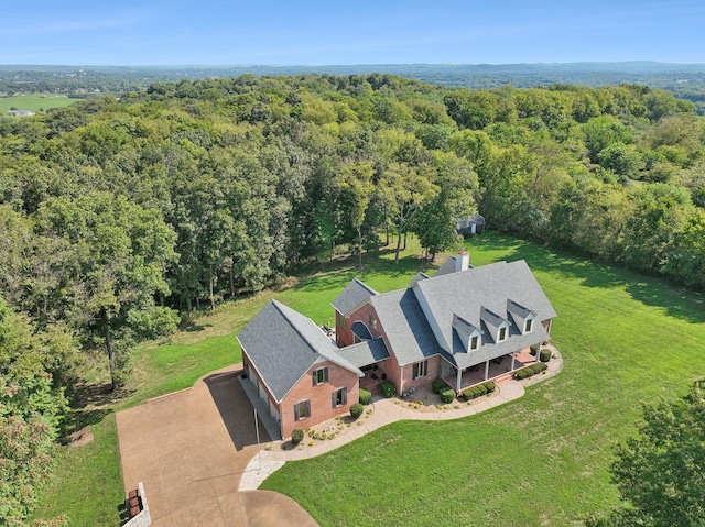 drone / aerial view featuring a view of trees