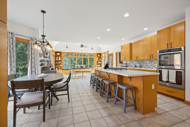 kitchen featuring light tile patterned floors, sink, stainless steel appliances, and backsplash