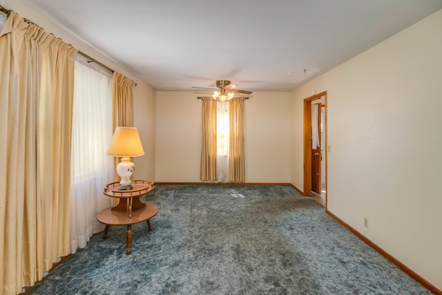 carpeted empty room featuring ceiling fan