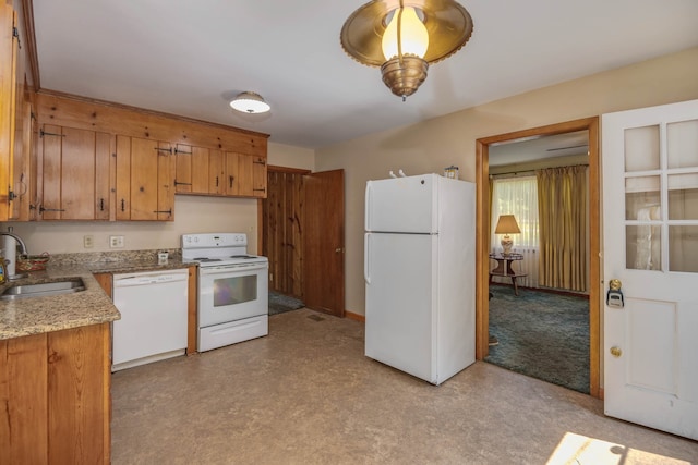 kitchen with white appliances, sink, and light colored carpet