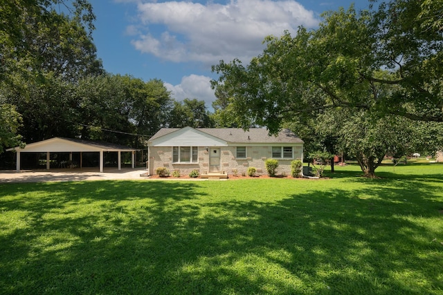 back of house with a carport and a lawn