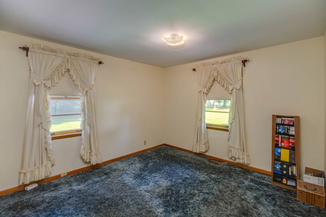 carpeted empty room featuring a wealth of natural light