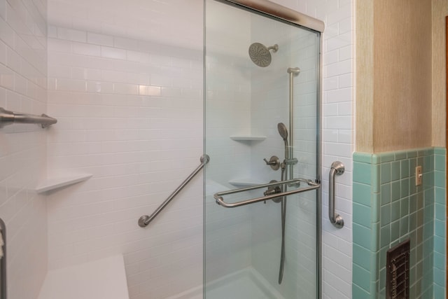 bathroom featuring a shower with shower door