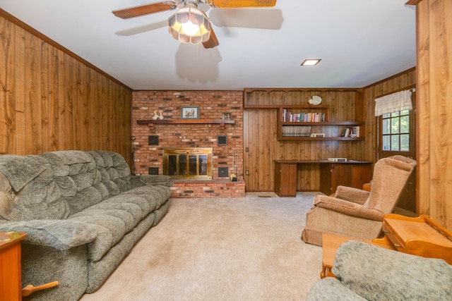 carpeted living room with wooden walls, a fireplace, ornamental molding, and ceiling fan