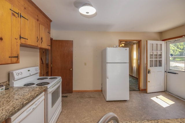 kitchen featuring white appliances and light stone countertops