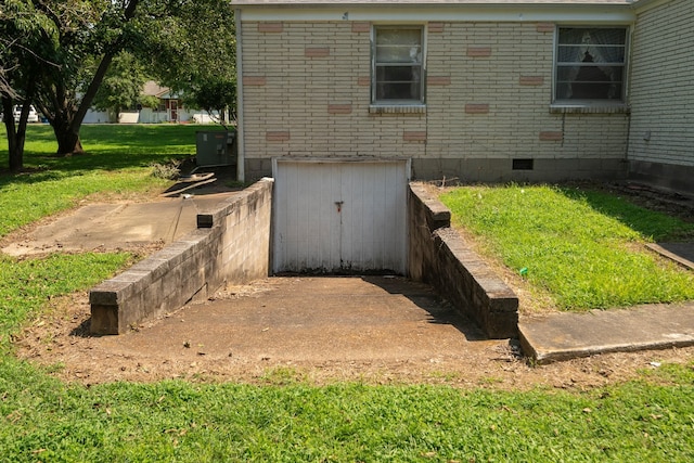 view of storm shelter with a yard