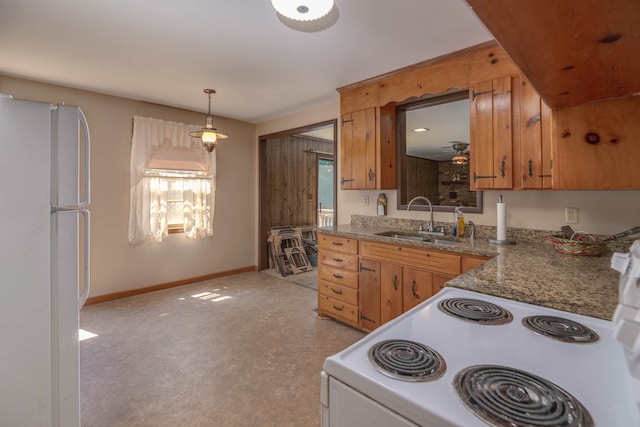 kitchen with pendant lighting, ceiling fan, sink, white fridge, and range