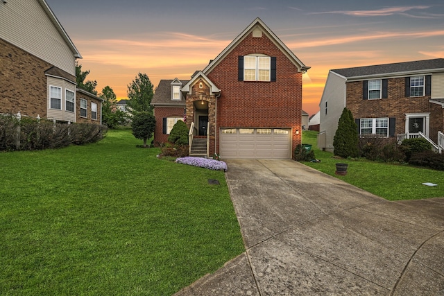 front of property featuring a yard and a garage