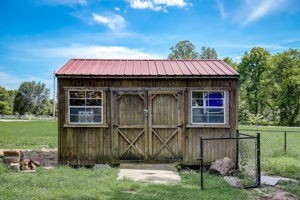 view of outdoor structure featuring a lawn