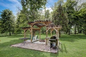 view of yard with a pergola and a fire pit