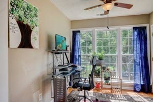 office space with wood-type flooring and ceiling fan