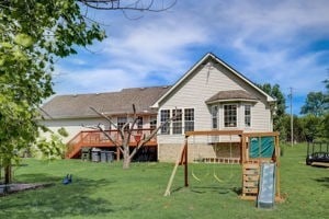 view of jungle gym with a lawn and a deck