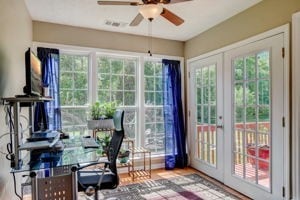 office space with ceiling fan, hardwood / wood-style flooring, and a wealth of natural light