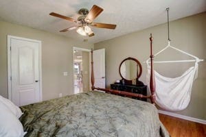 bedroom with ceiling fan and hardwood / wood-style flooring