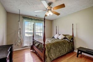 bedroom featuring hardwood / wood-style floors and ceiling fan