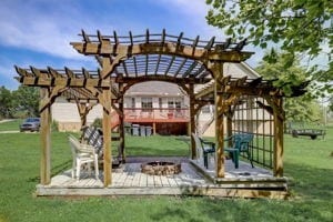 exterior space with a pergola, a fire pit, a deck, and a yard