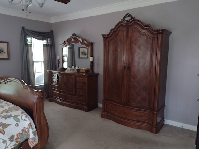 carpeted bedroom with ceiling fan and crown molding