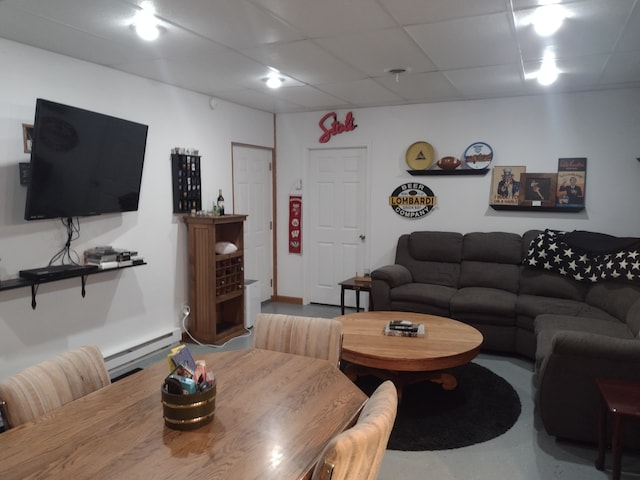 living room featuring baseboard heating and a drop ceiling