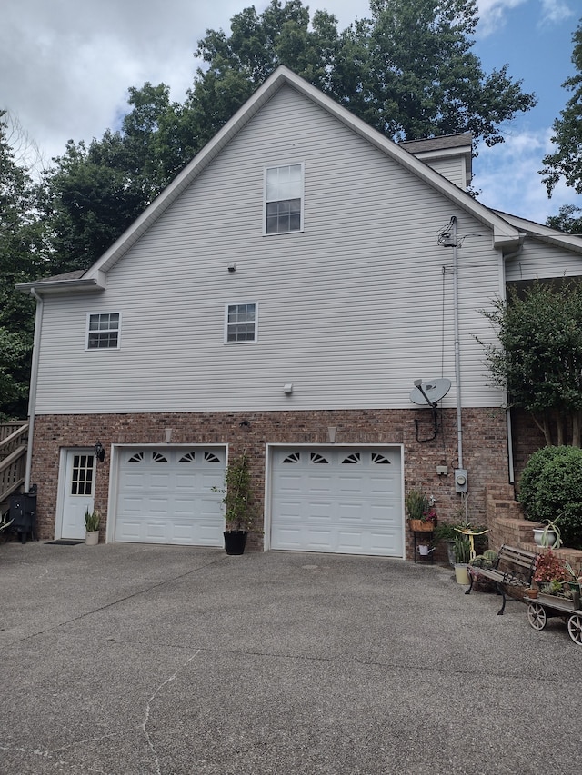 view of side of home featuring a garage