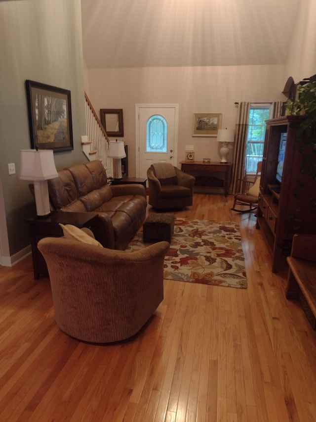 living room with lofted ceiling and light hardwood / wood-style floors