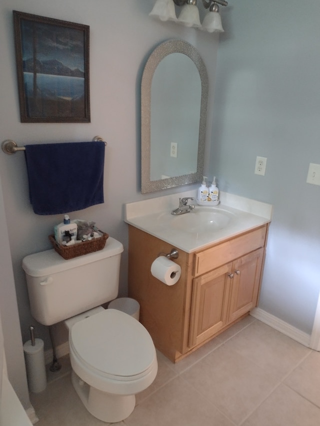 bathroom featuring tile patterned floors, vanity, and toilet