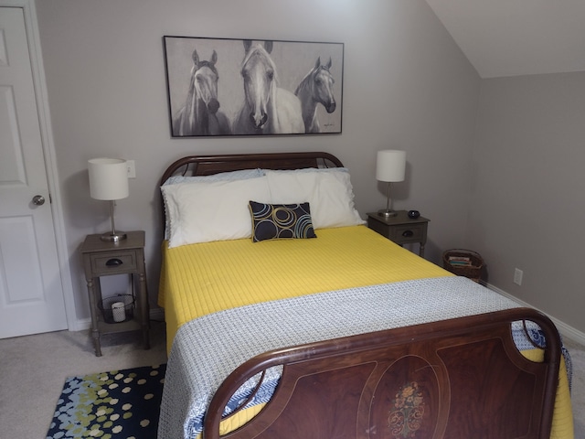 bedroom with lofted ceiling and carpet