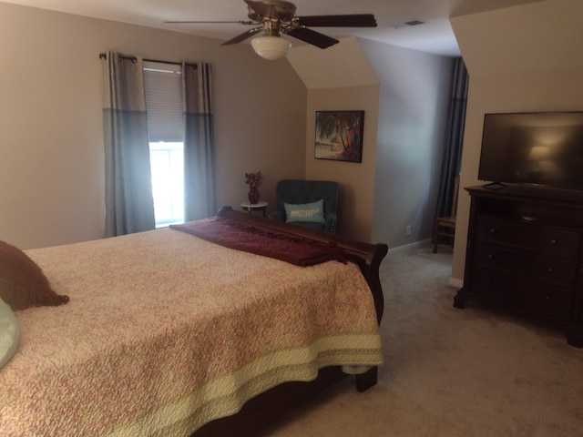 bedroom with lofted ceiling, light colored carpet, and ceiling fan