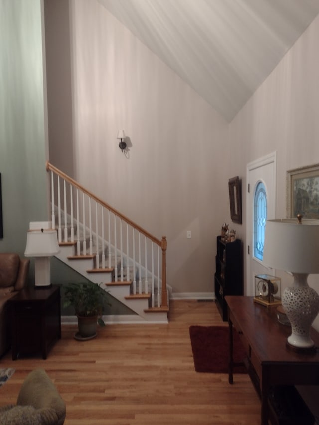 foyer with light hardwood / wood-style flooring and vaulted ceiling