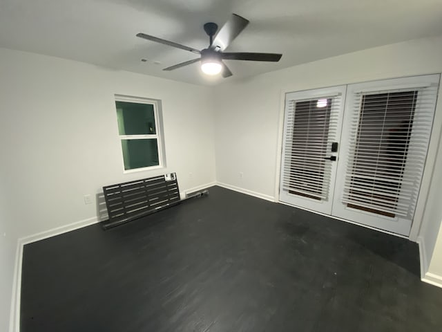 empty room featuring ceiling fan and french doors