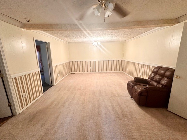 unfurnished room featuring ceiling fan, a textured ceiling, and carpet floors