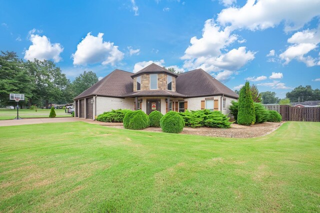 588 E Church St, Alamo, TN 38001 - view of front of home with brick siding, an attached garage, fence, driveway, and a front lawn
