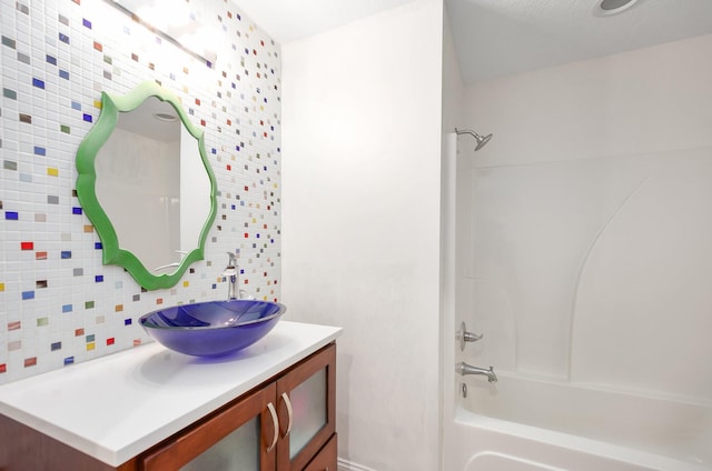 588 E Church St, Alamo, TN 38001 - bathroom with washtub / shower combination, backsplash, and vanity