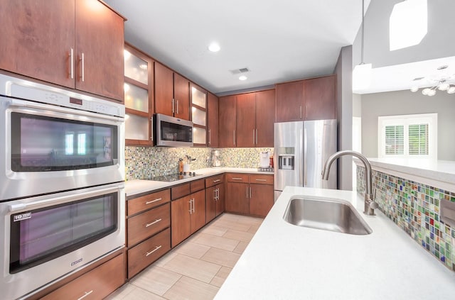 588 E Church St, Alamo, TN 38001 - kitchen featuring tasteful backsplash, light countertops, appliances with stainless steel finishes, glass insert cabinets, and a sink