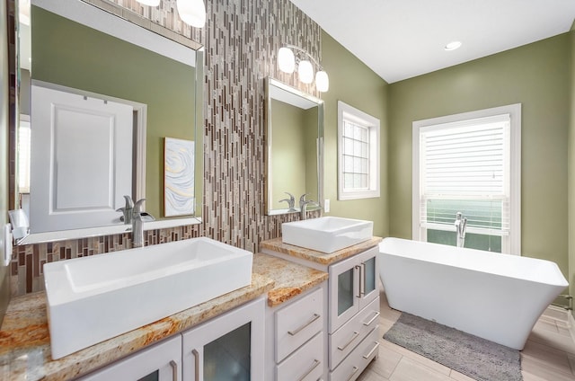 588 E Church St, Alamo, TN 38001 - full bath with double vanity, a freestanding tub, a sink, and decorative backsplash