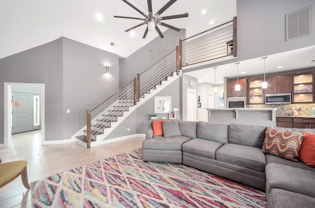 588 E Church St, Alamo, TN 38001 - living area with high vaulted ceiling, a ceiling fan, visible vents, baseboards, and stairway