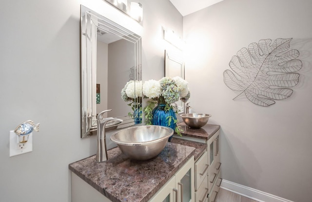 588 E Church St, Alamo, TN 38001 - bathroom with double vanity, a sink, and baseboards