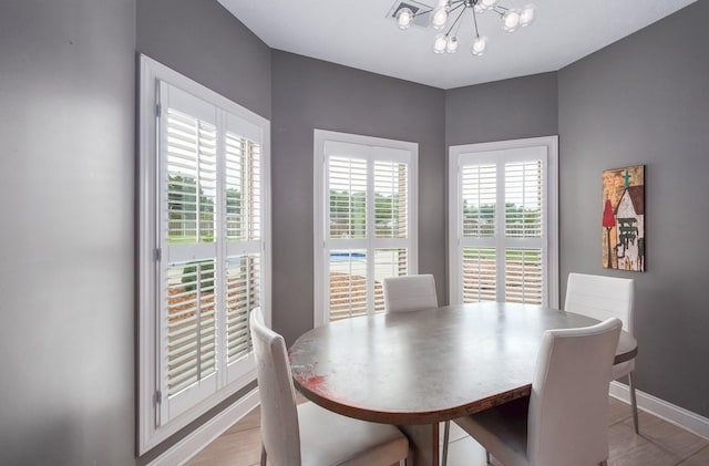 588 E Church St, Alamo, TN 38001 - dining room with a chandelier, light wood-type flooring, and baseboards